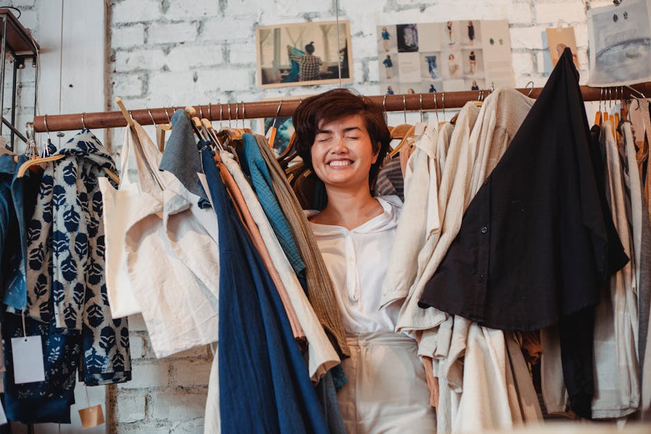 Smiling woman explores stylish clothing in a boutique, enjoying shopping indoors.