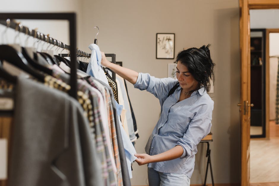 A woman examines clothes on a rack in a stylish boutique, considering her shopping options.